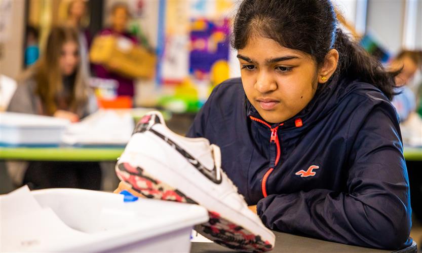 Students sketch shoes during art class